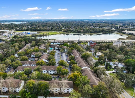 an aerial view of a neighborhood with houses and a lake