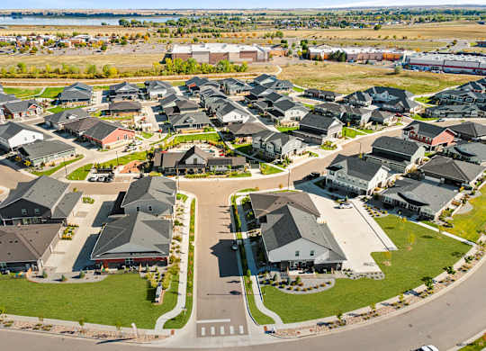 A suburban neighborhood with houses and a road.