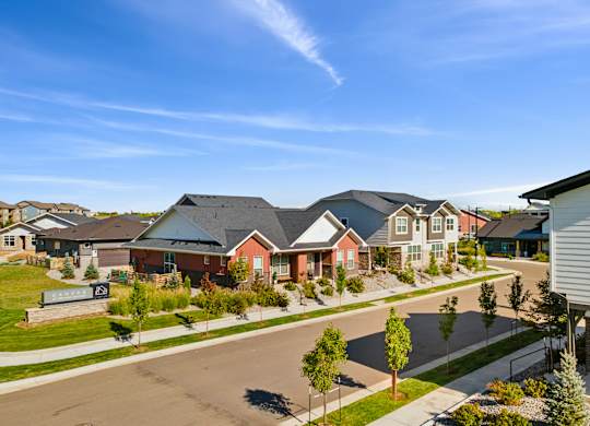 A row of houses with a clear blue sky above them.