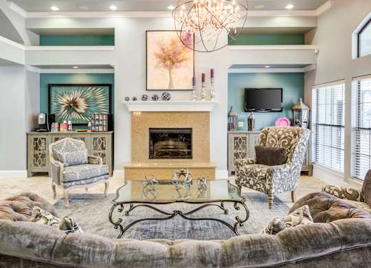 A living room with a fireplace and a chandelier.