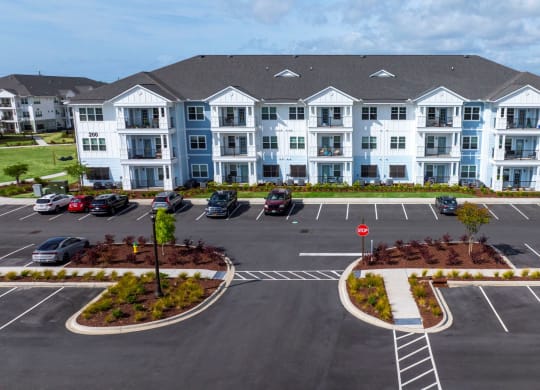 an aerial view of an apartment building in a parking lot