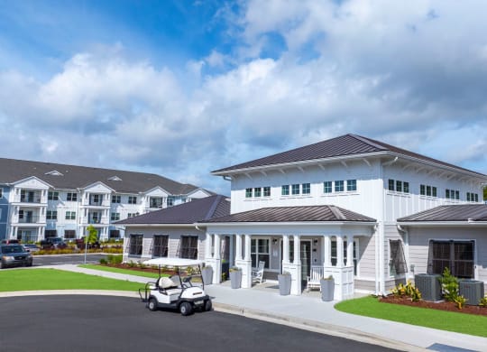a large white building with a golf cart parked in front of it