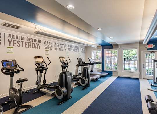 A gym with a row of stationary bikes and a sign that says