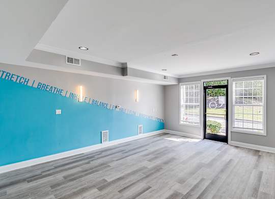 A room with a blue wall and a quote on it.