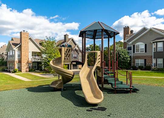 A playground with a slide and a swing set.