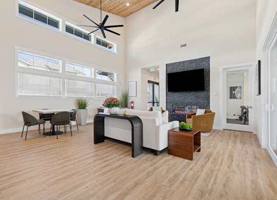A modern living room with a dining table and a fireplace.
