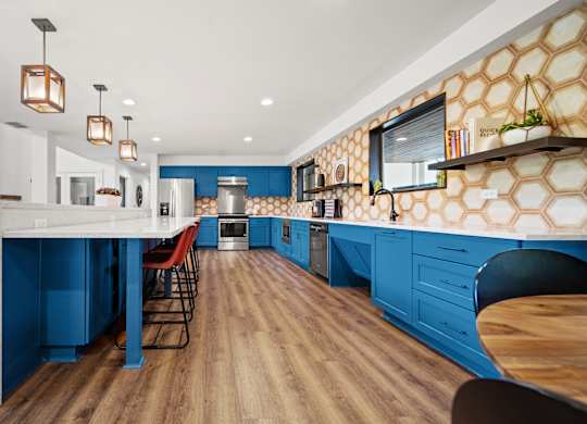 a kitchen with blue cabinets and white countertops