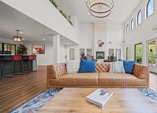 a living room with a couch and coffee table in front of a fireplace