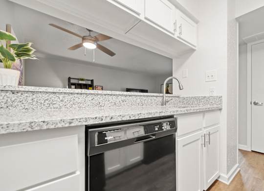 a kitchen with an island and a ceiling fan