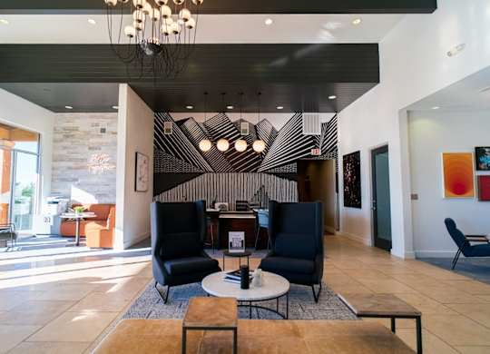 A modern living room with a black and white striped wall.