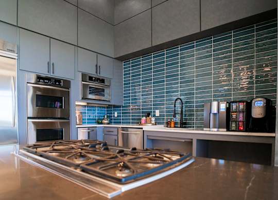 A modern kitchen with a stainless steel gas stove.