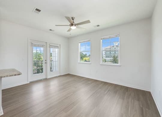a living room with hardwood floors and white walls