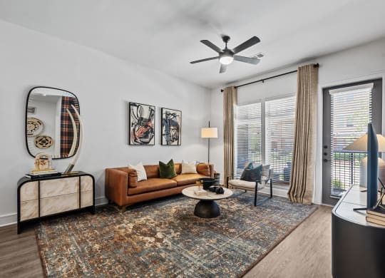 a living room with a couch and a ceiling fan
