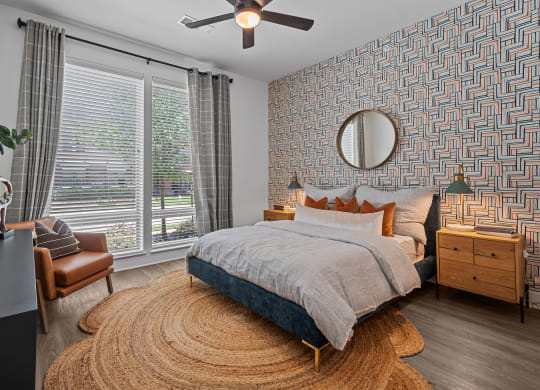 a bedroom with a bed and a ceiling fan