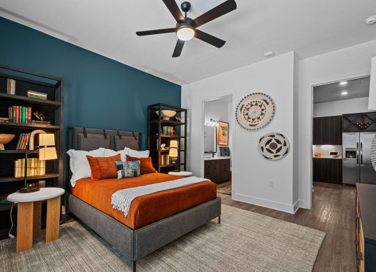 a bedroom with a bed and a ceiling fan