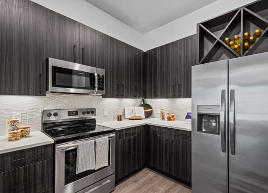 a kitchen with stainless steel appliances and brown cabinets