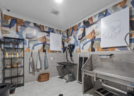 a kitchen with a large sink and a mural on the wall