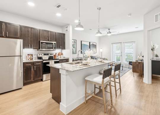 A kitchen with wooden cabinetry and granite countertops