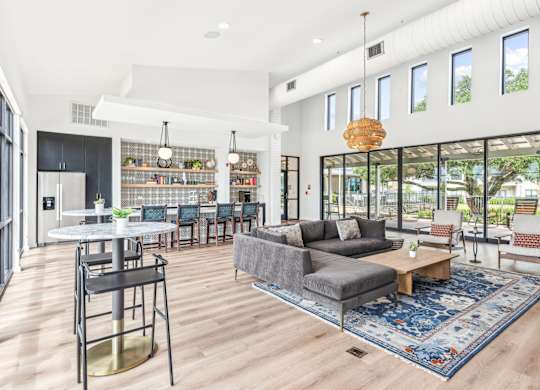 A modern living room with a grey couch and a round table.