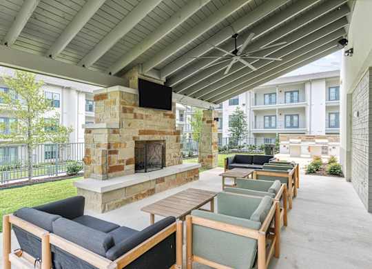 A patio with a fireplace and seating area.
