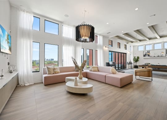 a living room with a pink couch and a coffee table