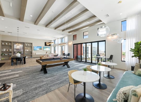 a living room with a pool table and couches