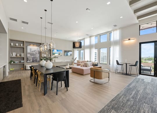 a living room and dining room with a table and chairs
