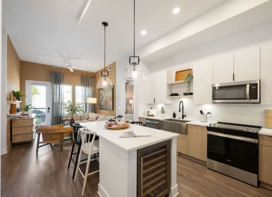 a kitchen and living room with an island and a dining table