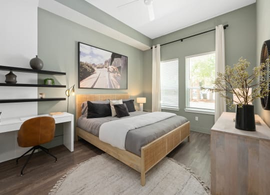 an image of a bedroom with a bed and a desk