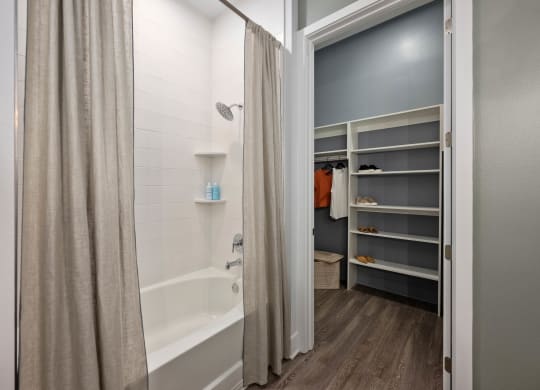 a bathroom with a urinal and a shower in it