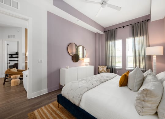 a bedroom with purple walls and a white bed