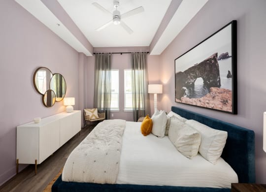 a bedroom with pink walls and a large bed