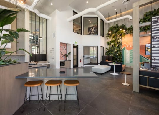a lobby with a table and three stools