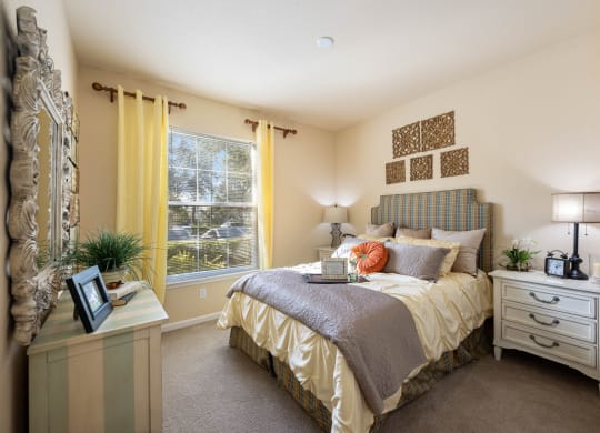 A queen sized bed in a spacious bedroom