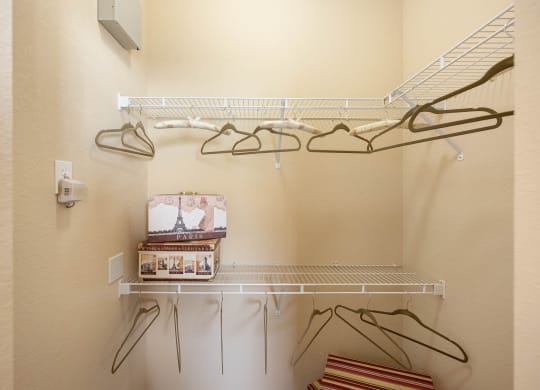 A walk in closet with shelving