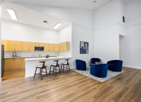 a living room with a kitchen and a table and chairs