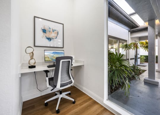 a home office with a desk and a window