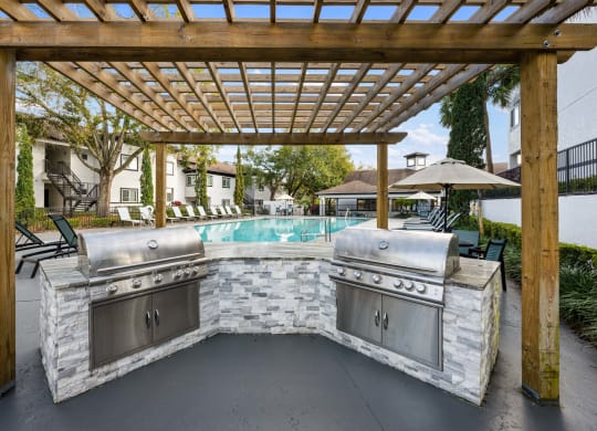 A set of grills overlooking the outdoor pool