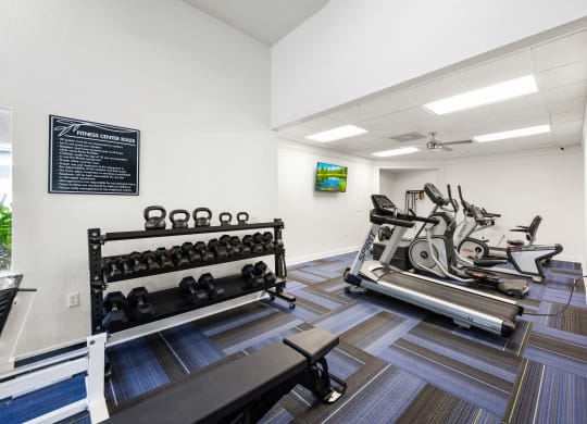 A gym equipped with free weights and treadmills