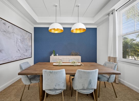 a dining room with blue wallpaper and a wooden table and chairs