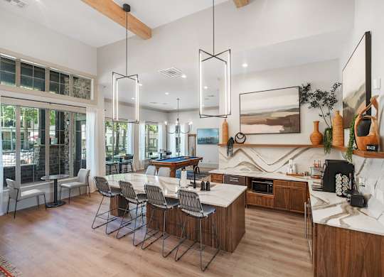 A modern kitchen with a dining table and chairs.