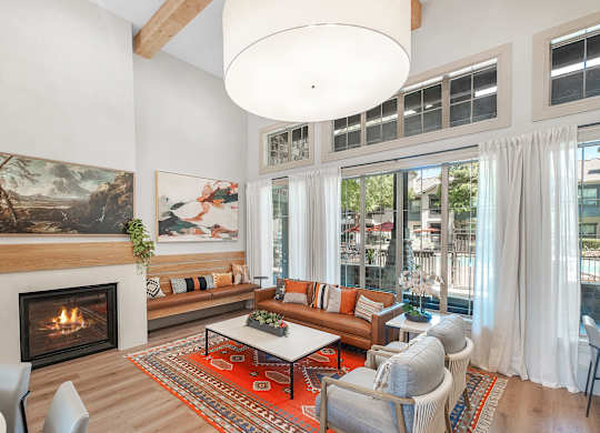 A living room with a fireplace and a painting on the wall.