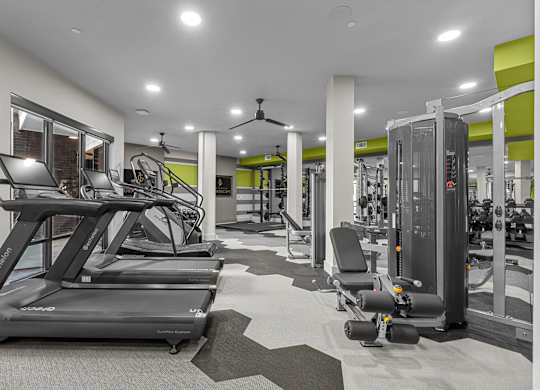 A gym with treadmills, weights, and other exercise equipment.
