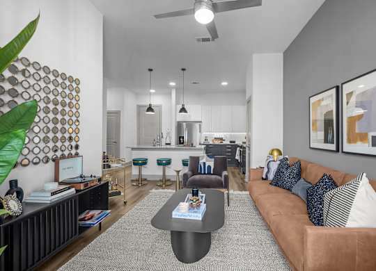 A living room with a brown couch and a coffee table.