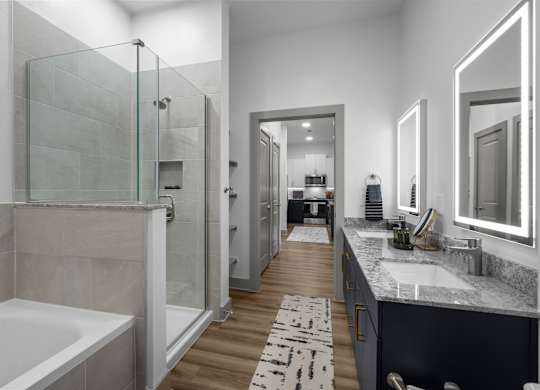 A modern bathroom with a walk-in shower and a bathtub.