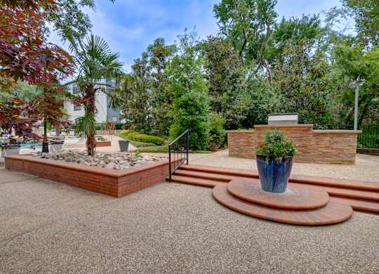 a fenced in area with stairs and a fountain
