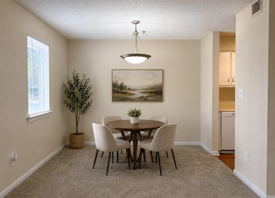 A dining room with a table and chairs.