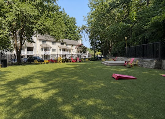 A park with a red object on the grass.