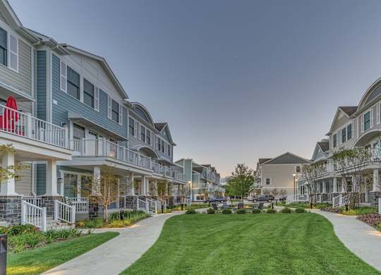 A green space in the middle of a townhome complex.