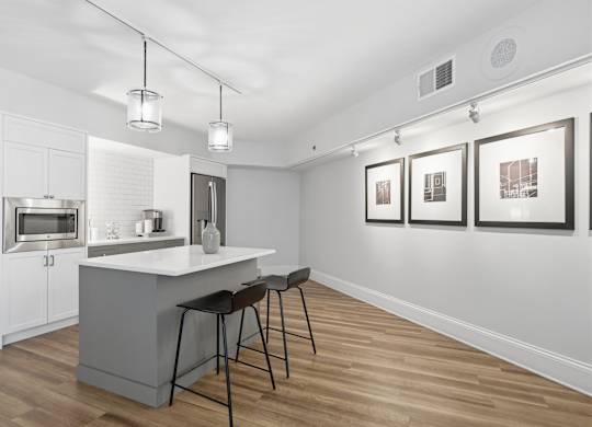 A kitchen with a bar stool and a counter.